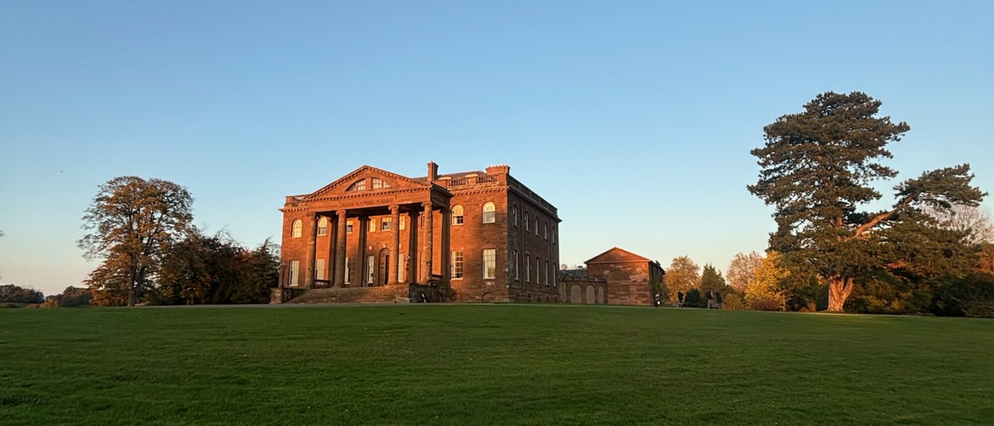 Georgian country house at golden hour in Shropshire parkland