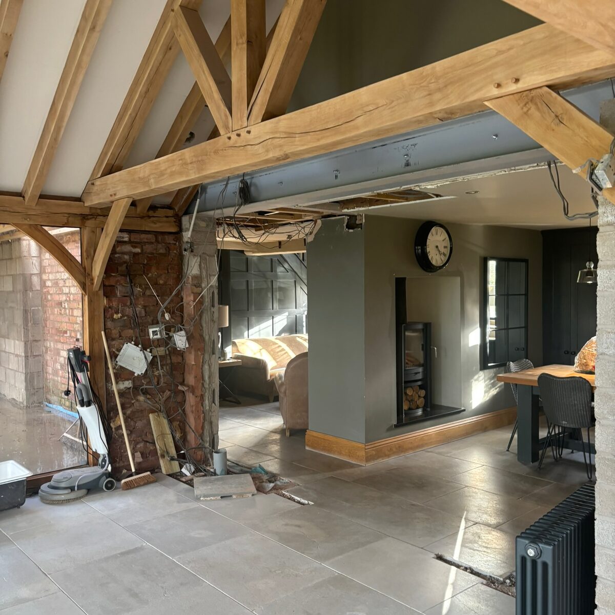Living space mid-conversion with exposed oak trusses