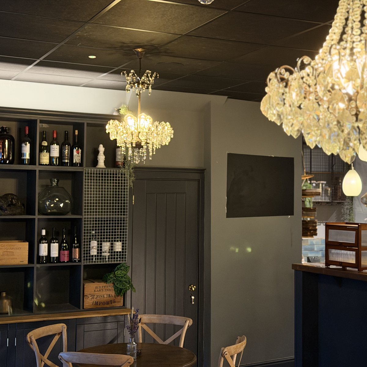Wine shelving and chandeliers in the bar area