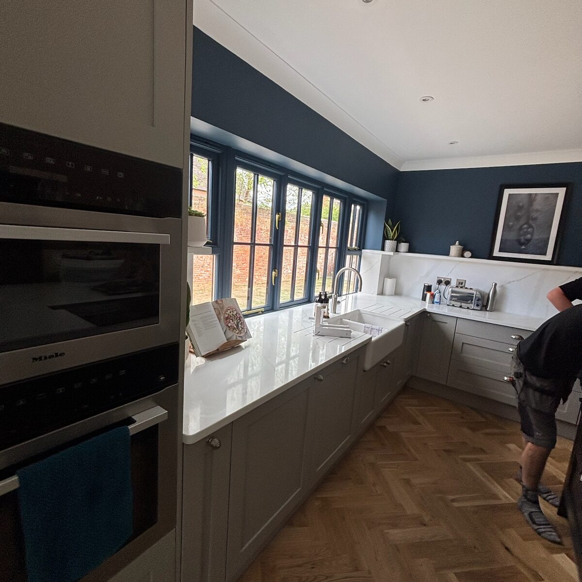 Kitchen with navy units and under-cabinet lighting