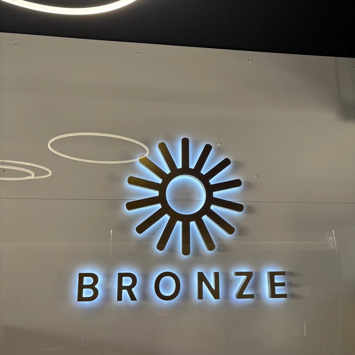 Backlit salon logo on the finished wall
