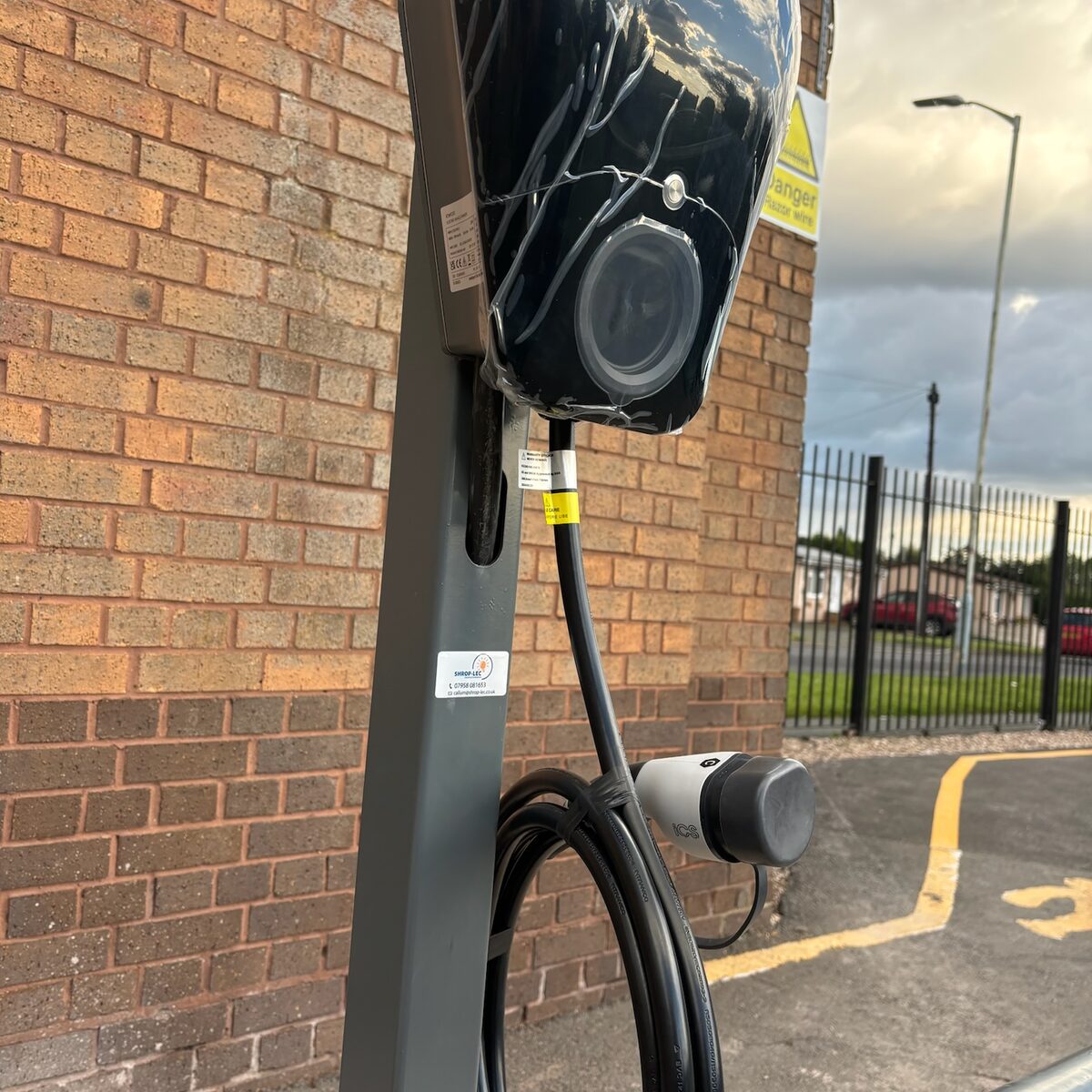 Wall-mounted charger above the protective hoop